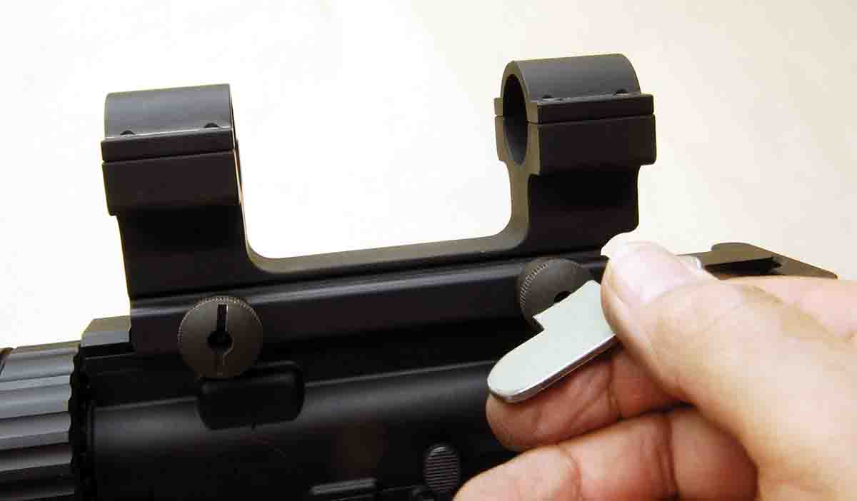 This scope mount for ARs uses a simple slotted clamp nut that fits a Weaver driver.